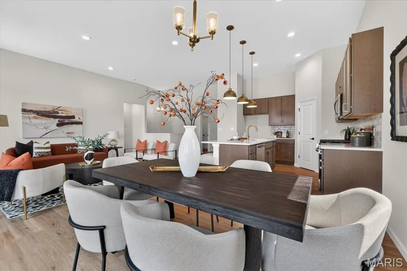 The open breakfast area flows effortlessly from the kitchen, providing plenty of room for family dinners or weekend gatherings while large windows fill the space with natural light. — 86 River Wind Drive, St Charles, MO 63301