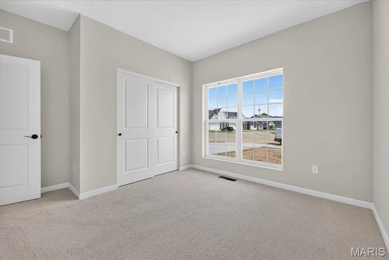 The generously sized secondary bedrooms provide comfortable accommodations for family or guests, each featuring large windows, ample closet space, and a bright, inviting atmosphere — 86 River Wind Drive, St Charles, MO 63301