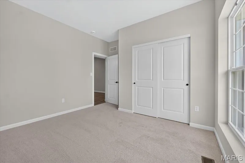 Designed with flexibility in mind, the secondary bedrooms offer plenty of space for children, guests, or a dedicated home office while providing abundant natural light and convenient closet storage. — 86 River Wind Drive, St Charles, MO 63301