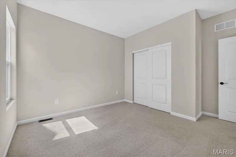 These well-appointed secondary bedrooms feature neutral finishes, generous closet space, and abundant natural light, making them easy to personalize for any stage of life. — 86 River Wind Drive, St Charles, MO 63301