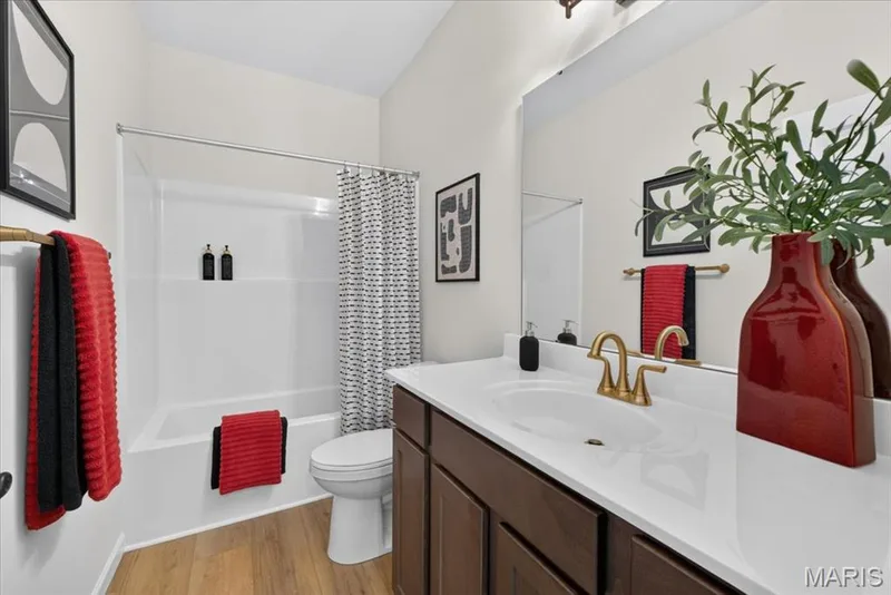 Featuring clean lines and neutral finishes, the hall bath includes a spacious vanity, abundant storage, and a full tub/shower combination, offering both style and practicality for everyday use. — 86 River Wind Drive, St Charles, MO 63301