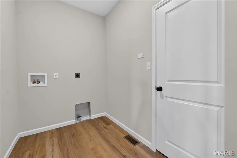 The conveniently located main-floor laundry room offers dedicated washer and dryer hookups, ample space for storage, and easy access to the main living areas, making everyday chores simple and efficient. — 86 River Wind Drive, St Charles, MO 63301