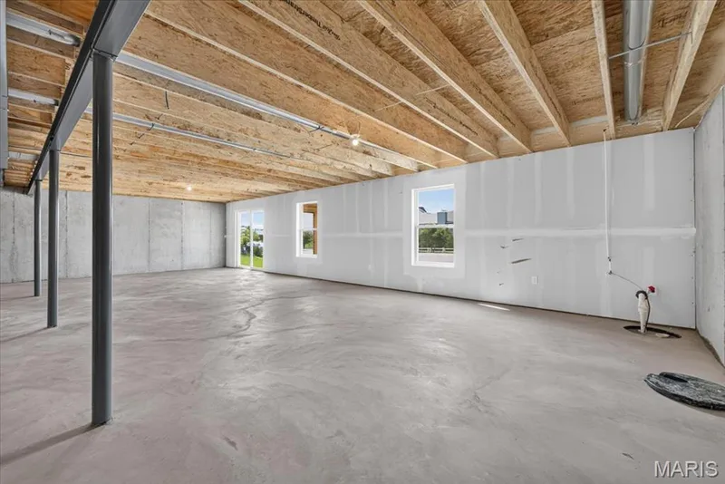 Enjoy the flexibility of a generous walk-out lower level featuring large windows, patio access, and ample space for future bedrooms, a family room, game room, or entertaining area, while still preserving plenty of storage. — 86 River Wind Drive, St Charles, MO 63301
