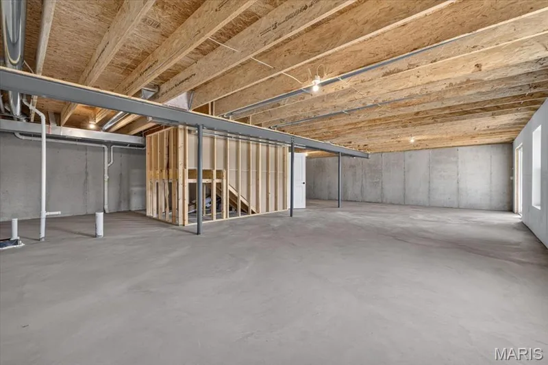 The unfinished walk-out lower level offers exceptional potential for future finishing, with an open layout, abundant natural light, and convenient access to the backyard. Whether you envision a media room, guest retreat, or additional entertaining space, this level is ready to bring your vision to life. — 86 River Wind Drive, St Charles, MO 63301
