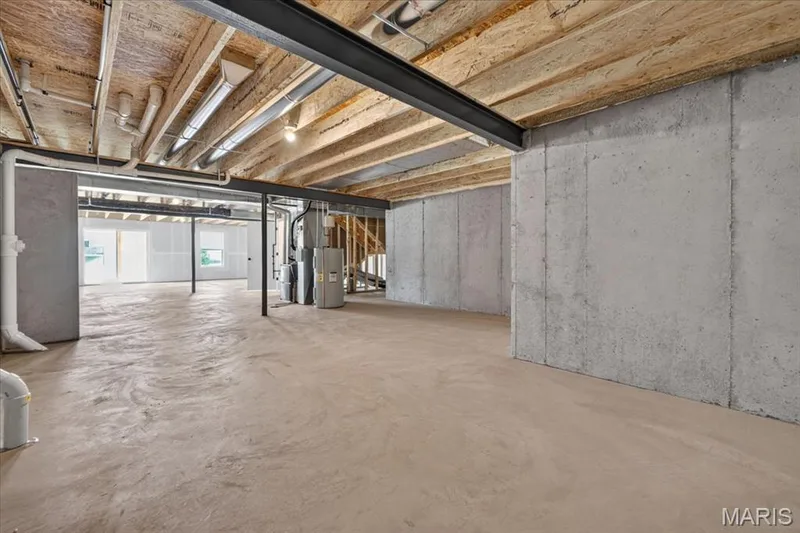 Maximize your home's potential with this spacious unfinished walk-out basement. Whether you envision an additional family room, extra bedroom and bath, home gym, or entertaining space, this level provides the perfect foundation while still offering generous storage space. — 86 River Wind Drive, St Charles, MO 63301
