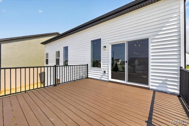 The expansive composite deck with durable aluminum railing provides the perfect setting for outdoor dining, entertaining, or simply unwinding. Accessible directly from the breakfast area, it creates a seamless indoor-outdoor living experience while overlooking the backyard. — 86 River Wind Drive, St Charles, MO 63301