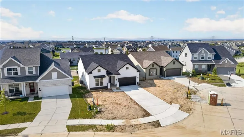 The aerial views highlight this home's exceptional setting within a growing community, featuring a spacious homesite, walk-out lower level, and convenient access to nearby amenities. Its elevated position and thoughtfully designed layout make it an outstanding place to call home. — 86 River Wind Drive, St Charles, MO 63301