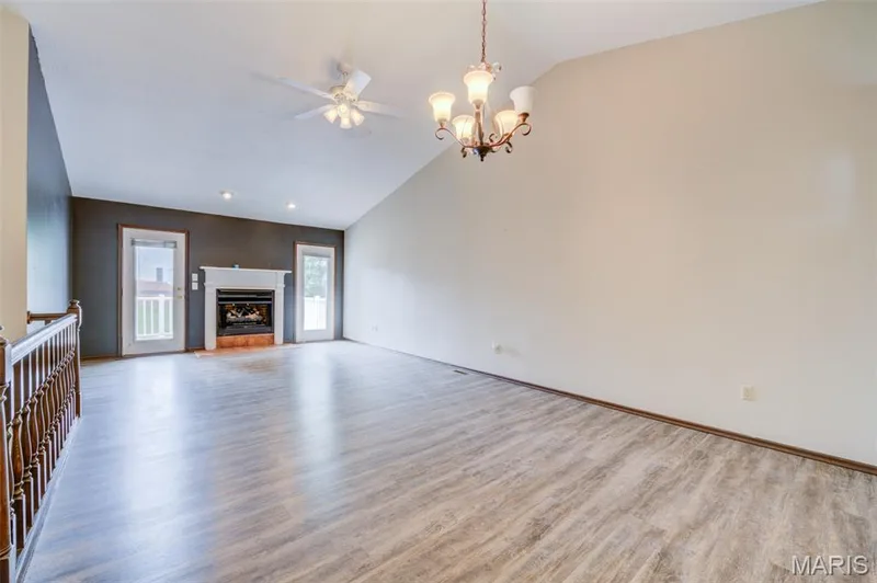 Notice the vaulted ceiling with ceiling fan combo, the new gas fireplace and 2 doors to the composite deck. — 1647 Chapman Court, St Charles, MO 63303