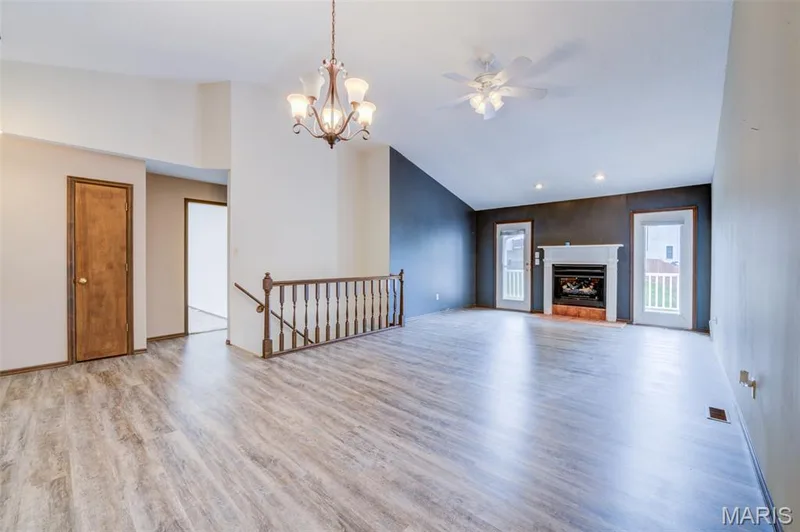 Open stairs to the lower level and hallway to the two main floor bedrooms and baths. — 1647 Chapman Court, St Charles, MO 63303