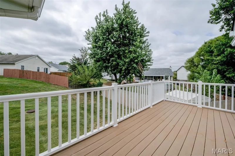 The doors on either side of the fireplace lead to the composite deck. — 1647 Chapman Court, St Charles, MO 63303