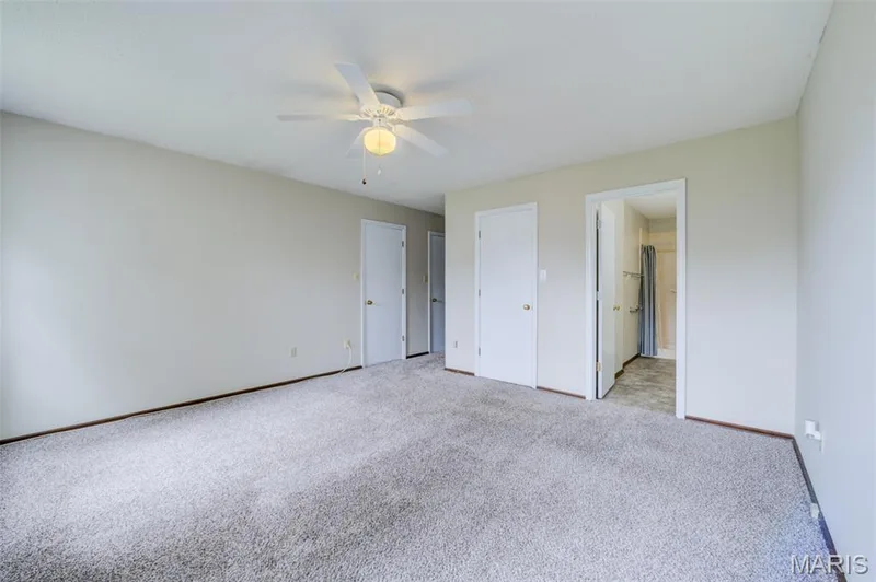The primary bedroom looking toward the bath and hallway. — 1647 Chapman Court, St Charles, MO 63303