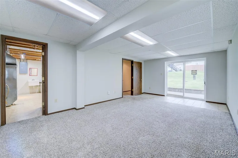 The lower-level rec room has NEW walk-out doors to the rear patio. — 1647 Chapman Court, St Charles, MO 63303