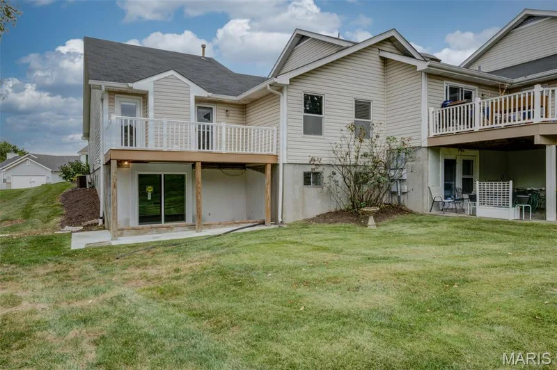 Here is the rear of the home showing the walkout basement with patio and deck above. — 1647 Chapman Court, St Charles, MO 63303