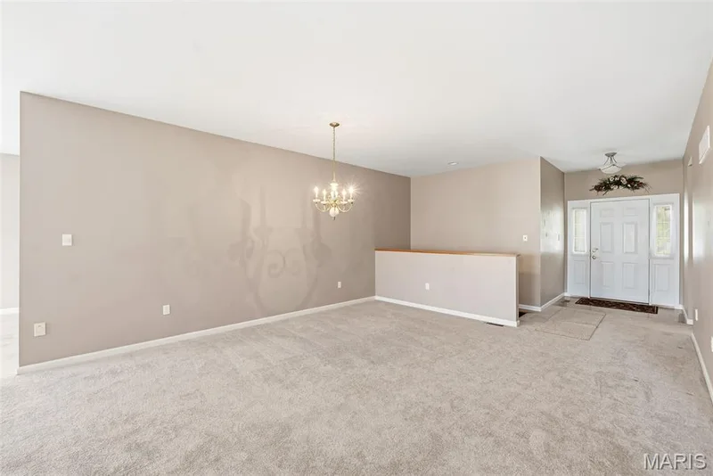 View from Living Room to Foyer and stairs to finished lower level — 1311 Pine Bluff Drive, St Charles, MO 63304
