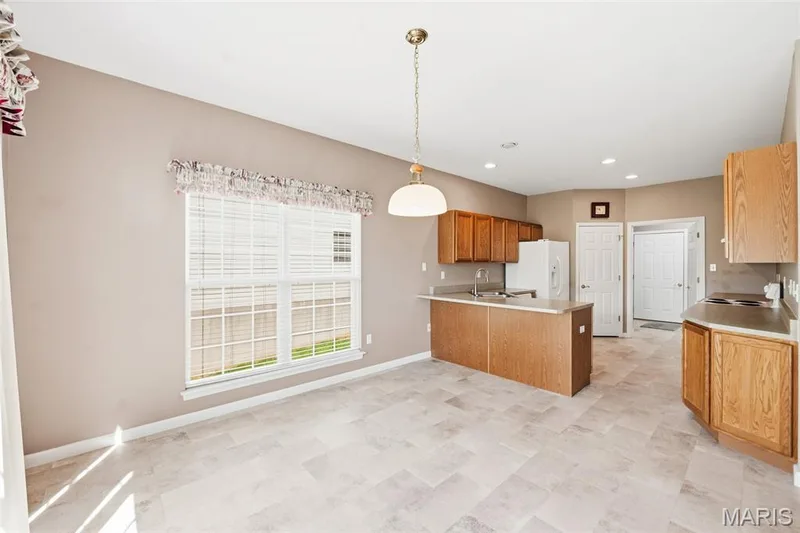 Breakfast Room into Kitchen — 1311 Pine Bluff Drive, St Charles, MO 63304