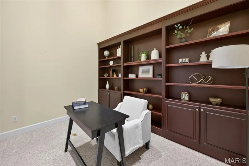 Home Office with glass doors, built-in shelving and cabinetry featuring  crown molding and a rich wood finish — 216 Woodland Place Court, St Charles, MO 63303