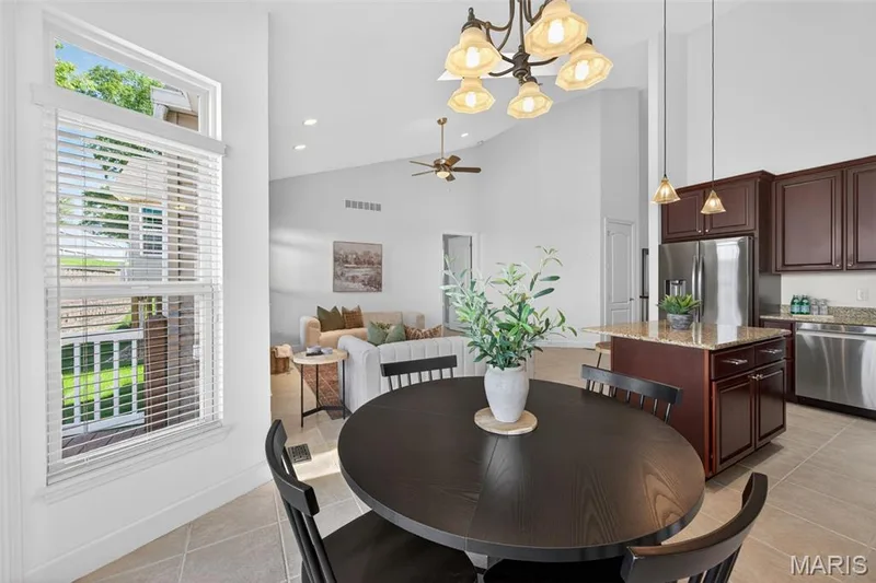 Open-concept featuring a vaulted ceiling with recessed lighting, an overhead ceiling fan, and a chandelier — 216 Woodland Place Court, St Charles, MO 63303