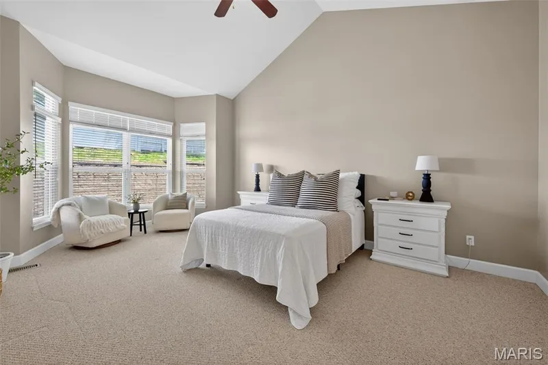Vaulted ceiling in primary bedroom featuring a 3 window bay and a sitting area — 216 Woodland Place Court, St Charles, MO 63303