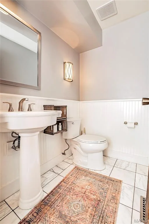 Main Floor half Bath features ceramic flooring and a Pedestal Sink. — 4600 Cliff Forest Drive, Wildwood, MO 63069