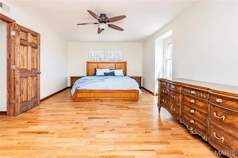 Master Bedroom Suite features lovely wood floors, solid six panel doors and a ceiling fan. — 4600 Cliff Forest Drive, Wildwood, MO 63069