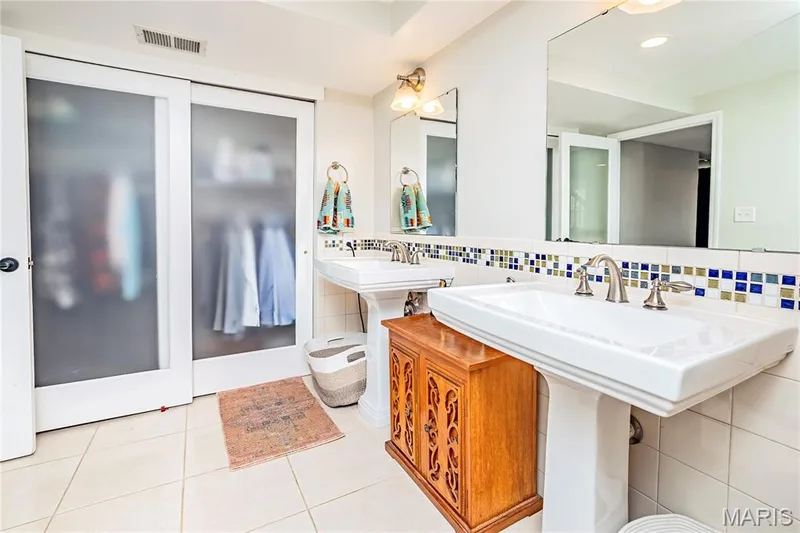 Lower Level Bathroom, double Pedestal Sinks, ceramic tile flooring. — 4600 Cliff Forest Drive, Wildwood, MO 63069