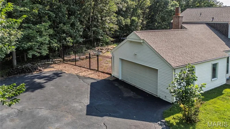 Over sized two car garage and wrought iron fence with gate. — 4600 Cliff Forest Drive, Wildwood, MO 63069