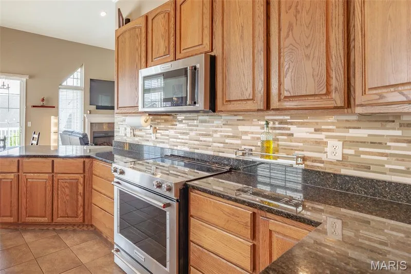 Beautiful Kitchen with granite countertops and open to floorplan! — 197 Woodland Place Court, St Charles, MO 63303