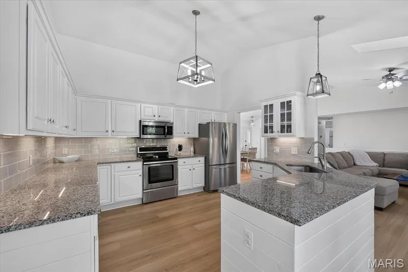 Granite countertops and stainless steel appliances bring style and convenience together — 2707 Post Meadows Drive, O'Fallon, MO 63368