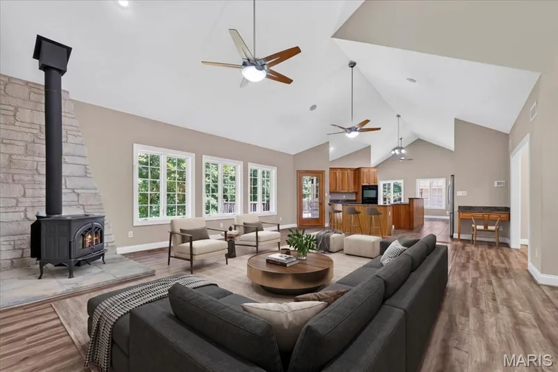 Stunning great room with 22-foot vaulted ceilings and a cozy wood-burning stove — 18517 Gredan Court, Wildwood, MO 63069