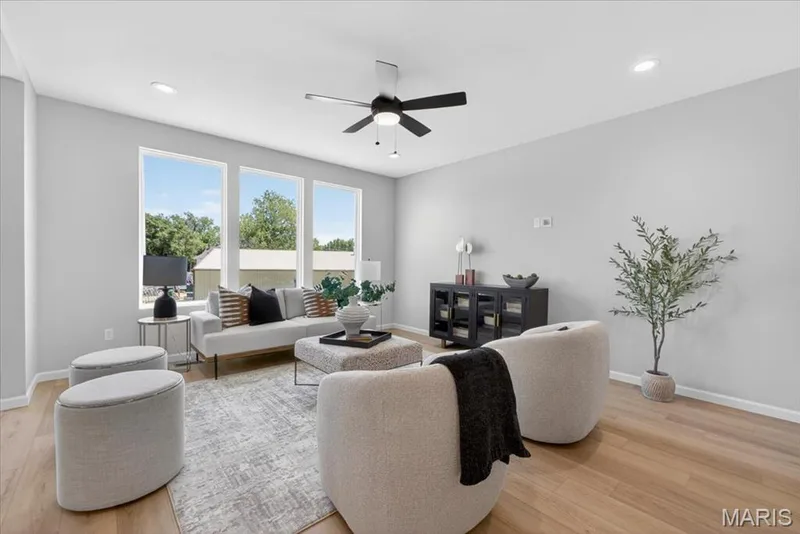 Family room view with window wall and ceiling fan — 30 River Wind Drive, St Charles, MO 63301