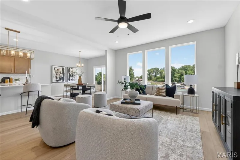 Family room view with window wall and ceiling fan — 30 River Wind Drive, St Charles, MO 63301