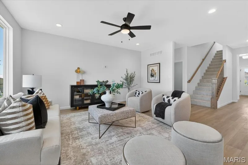 Family room view with window wall and ceiling fan — 30 River Wind Drive, St Charles, MO 63301