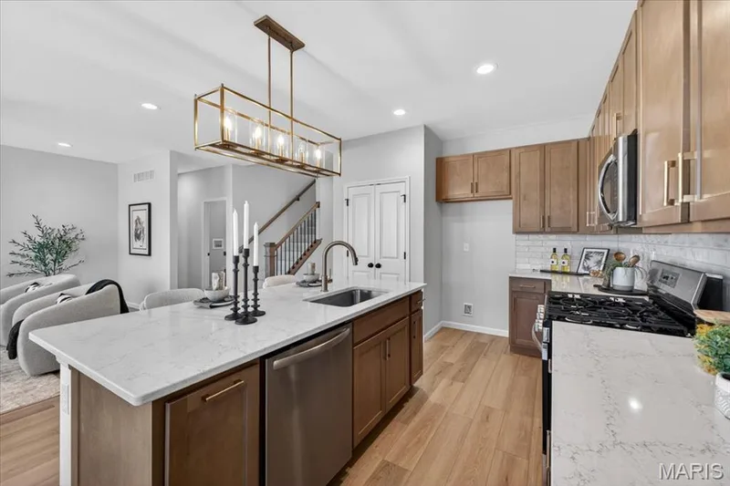 Kitchen area with custom cabinets, stainless steel gas appliances and Quartz countertops — 30 River Wind Drive, St Charles, MO 63301