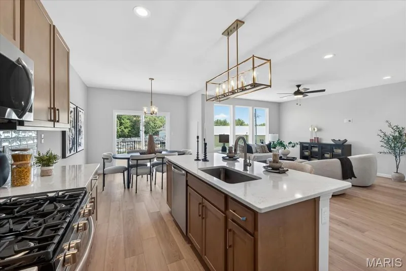 Kitchen area with custom cabinets, stainless steel gas appliances and Quartz countertops — 30 River Wind Drive, St Charles, MO 63301