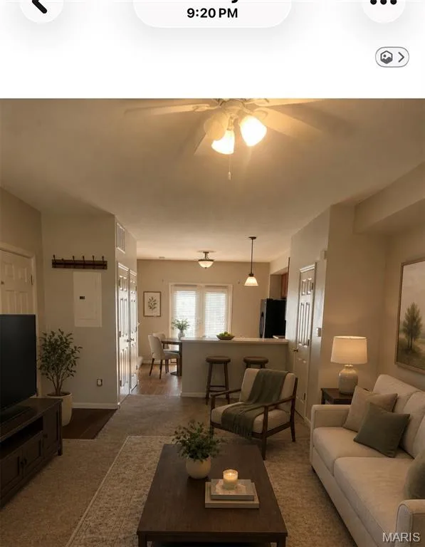 Open-concept living area featuring soft neutral wall tones and a ceiling fan — 3245 Domain Street, St Charles, MO 63301
