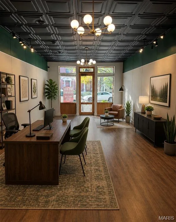 Spacious commercial interior featuring wood-finish flooring and a decorative pressed tin ceiling — 3245 Domain Street, St Charles, MO 63301