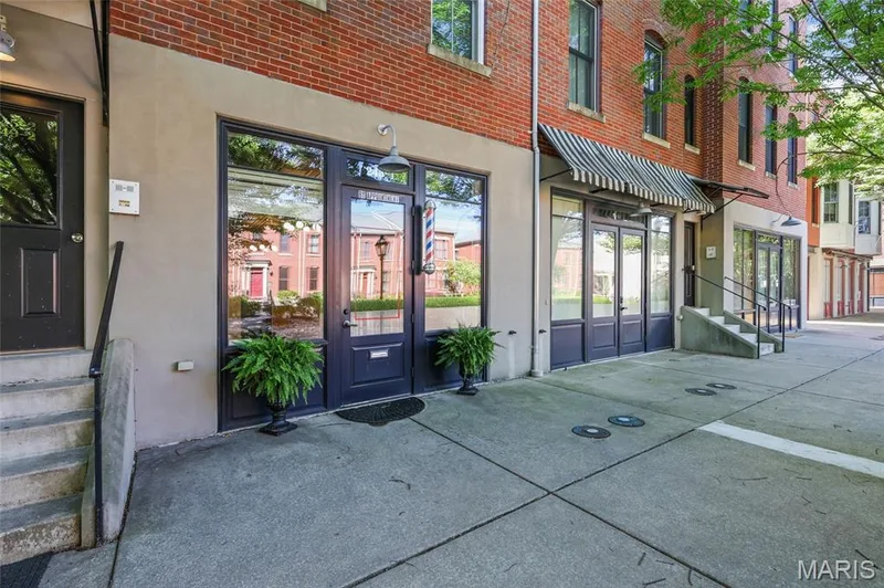 Brick facade building with multiple storefronts featuring large display windows and an awning — 3245 Domain Street, St Charles, MO 63301