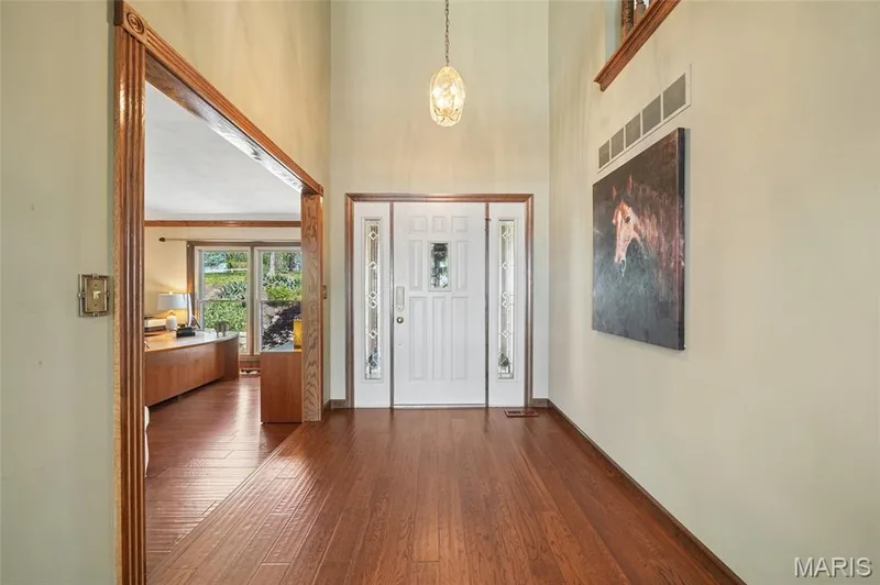Entryway featuring dark wood-style flooring and a high ceiling — 1553 Ridge Road, Wildwood, MO 63021