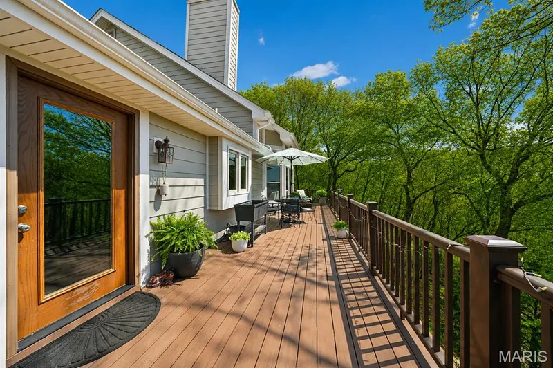 Spacious outdoor deck with wood-finish flooring and a continuous railing system — 1553 Ridge Road, Wildwood, MO 63021