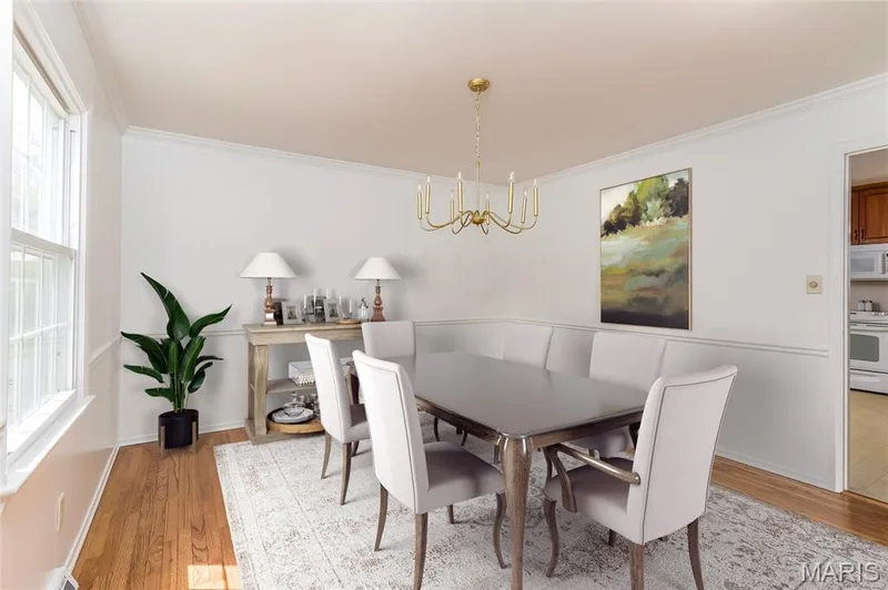 Dining room with gleaming hardwood floors and new chandelier. Virtually staged. — 250 Brixham Drive, Chesterfield, MO 63017