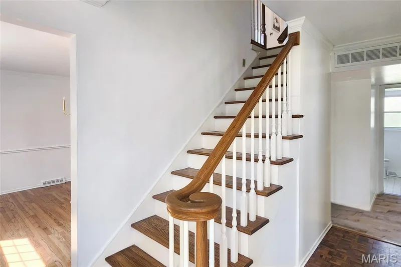 Entry hall with gleaming hardwood floors and new lighting. — 250 Brixham Drive, Chesterfield, MO 63017