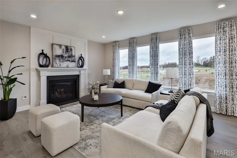 Great Room with a view of the Gas fireplace and window wall — 430 Farmhouse Drive, O'Fallon, MO 63385