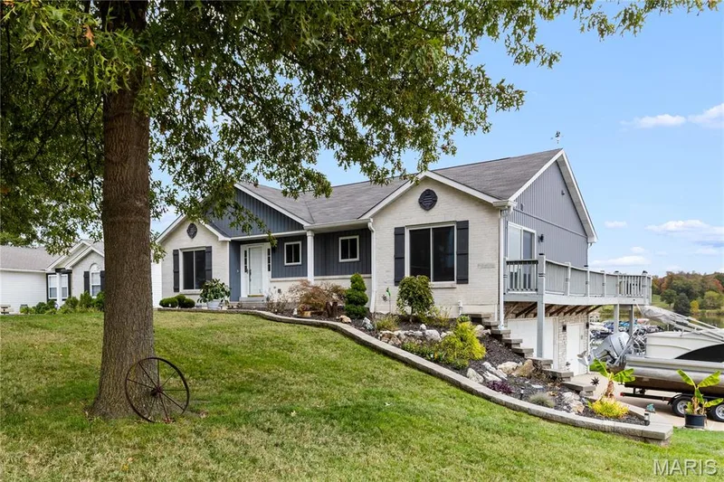 Ranch-style home featuring a front yard, a garage, brick siding, and a shingled roof — 10107 Greenbriar Court, Foristell, MO 63348