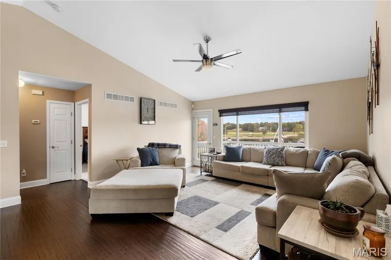 Living area featuring hardwood / wood-style floors, a ceiling fan, and high vaulted ceiling — 10107 Greenbriar Court, Foristell, MO 63348