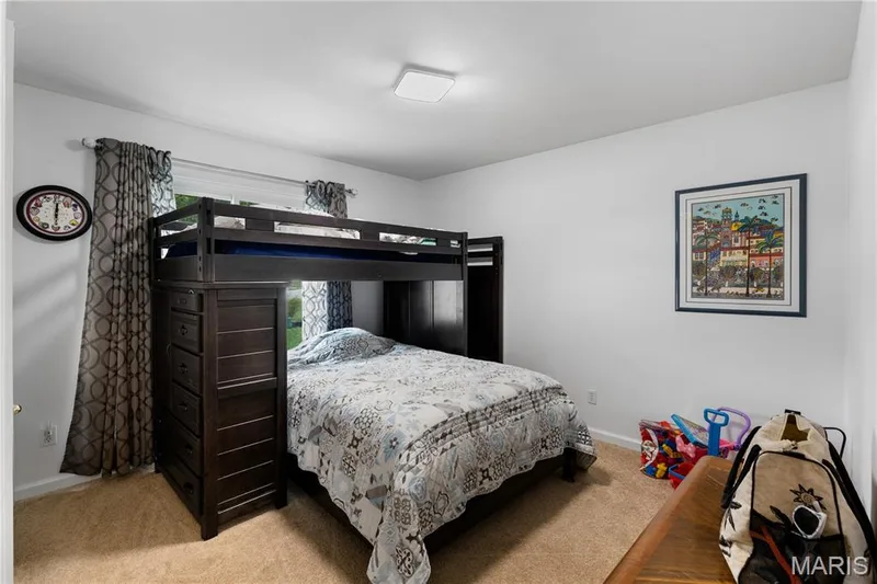 Bedroom featuring light carpet and baseboards — 10107 Greenbriar Court, Foristell, MO 63348