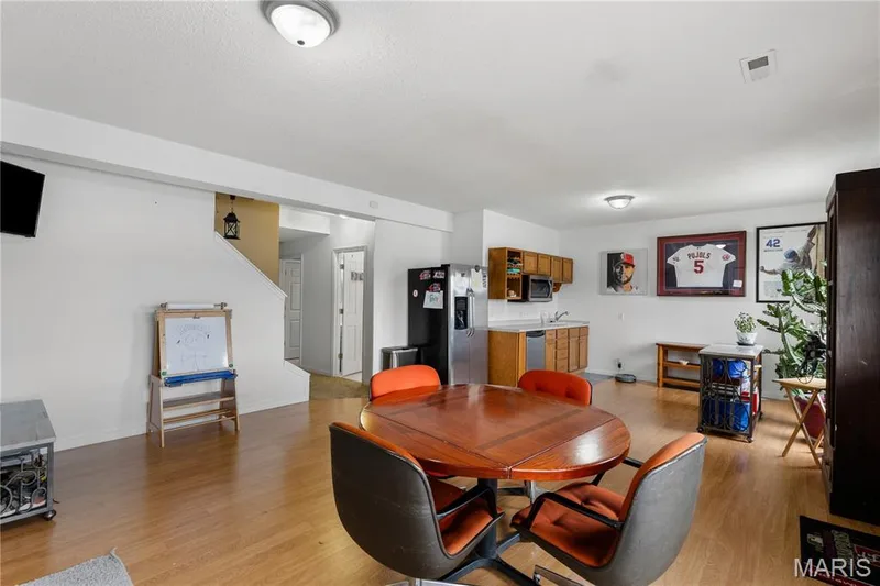 Dining room featuring light wood finished floors and baseboards — 10107 Greenbriar Court, Foristell, MO 63348