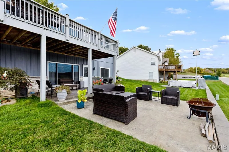 View of patio / terrace featuring a deck and an outdoor living space with a fire pit — 10107 Greenbriar Court, Foristell, MO 63348