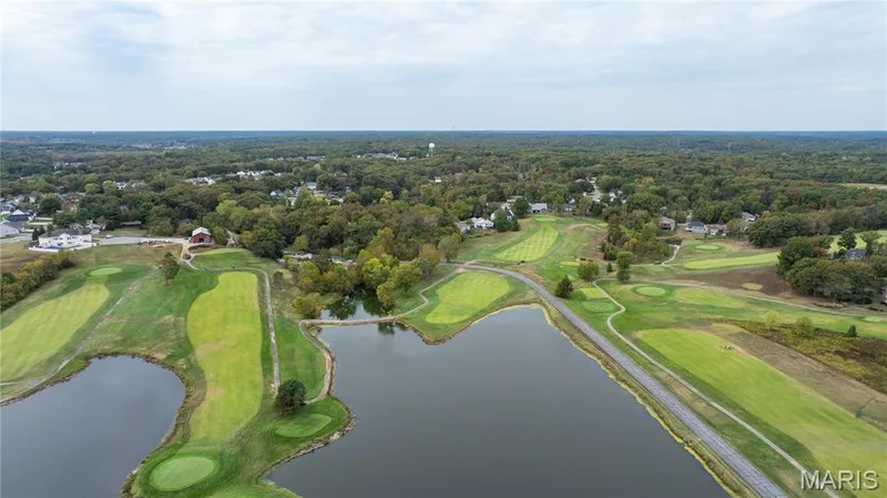 Aerial overview of property's location featuring a local golf course and a large body of water — 10107 Greenbriar Court, Foristell, MO 63348