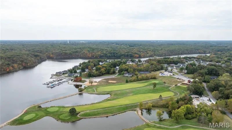 Drone / aerial view of a nearby body of water and a golf course — 10107 Greenbriar Court, Foristell, MO 63348