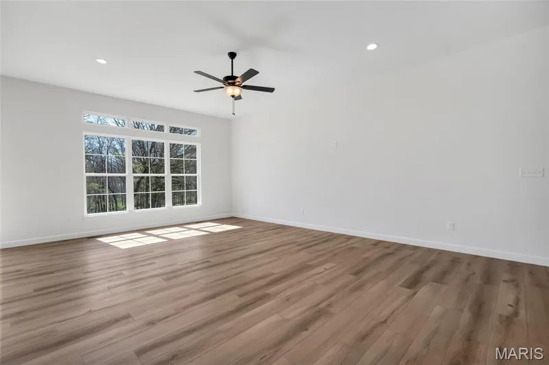 10 ft ceilings, transoms in back and triple window in the great room for natural lighting and taking in the beautiful view in back on this 3.05 acre lot. — 308 Schaper Estates Xing, Foristell, MO 63348